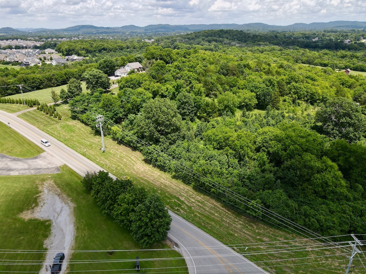 0 Thompson's Station Road East Thompson's Station, TN 37179 - Photo 12 of 15 a view of a lush green forest with a lake