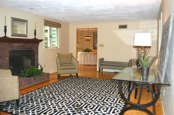 4 Dudley Road Lexington, MA 02421 - Photo 13 of 26 a bedroom with furniture and a fireplace