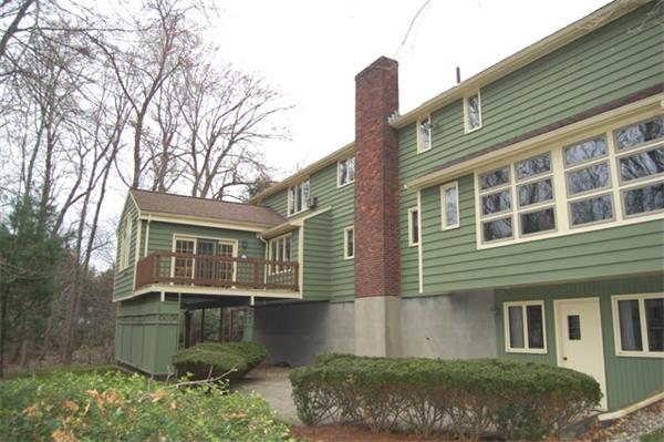 4 Dudley Road Lexington, MA 02421 - Photo 22 of 26 a front view of a house with a garden