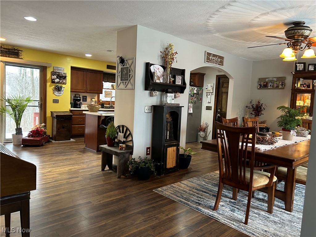 530 Midvale Mine Road Southeast Dennison, OH 44621 - Photo 16 of 42 Dining area with arched walkways, dark wood-style floors, a textured ceiling, a ceiling fan, and recessed lighting