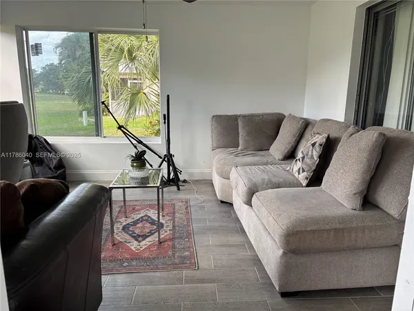 a living room with furniture and a large window