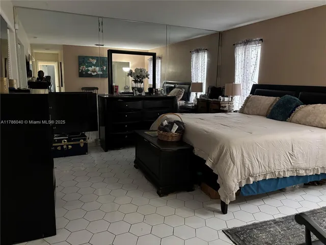 a bedroom with a bed window and dresser