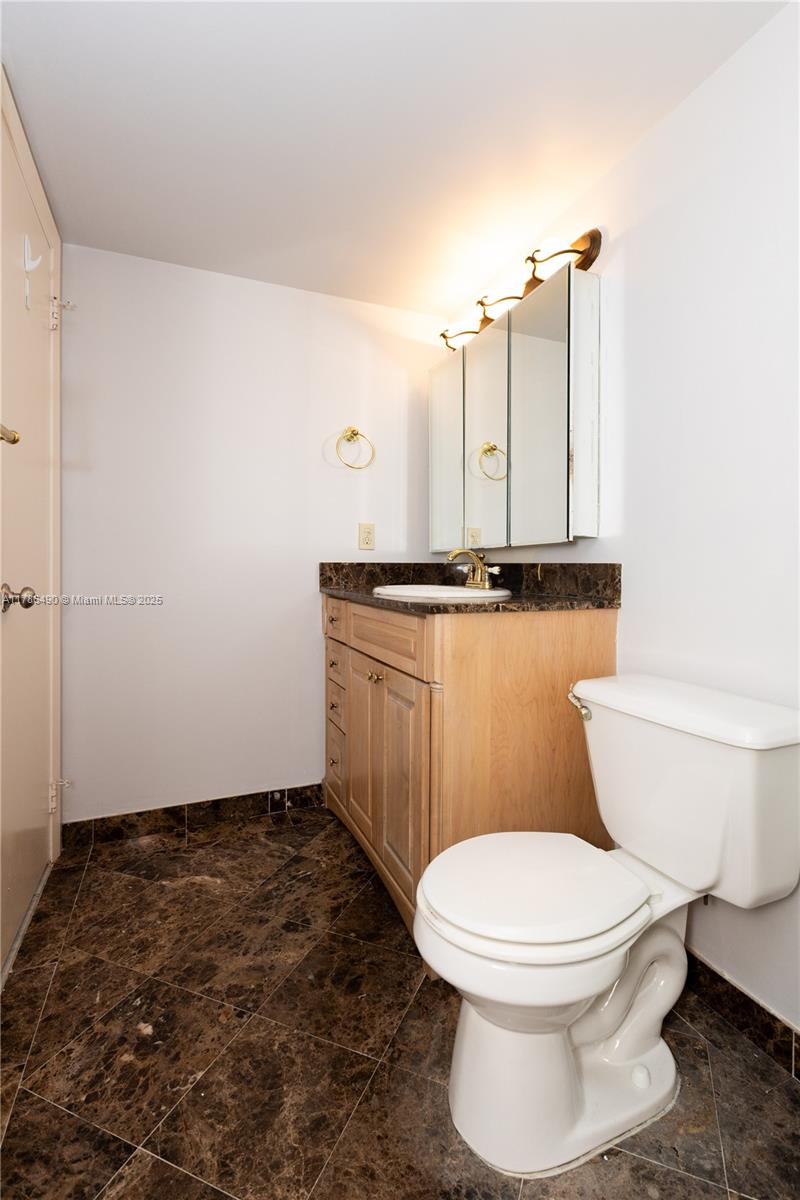 2750 Northeast 183rd Street, Unit 511 Aventura, FL 33160 - Photo 11 of 36 a bathroom with a toilet a sink and a mirror