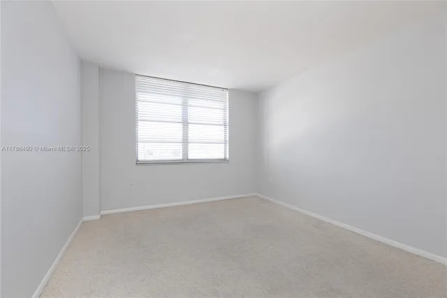 an empty room with a empty space and window