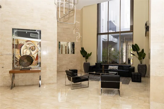 a living room filled with furniture and a painting on the wall