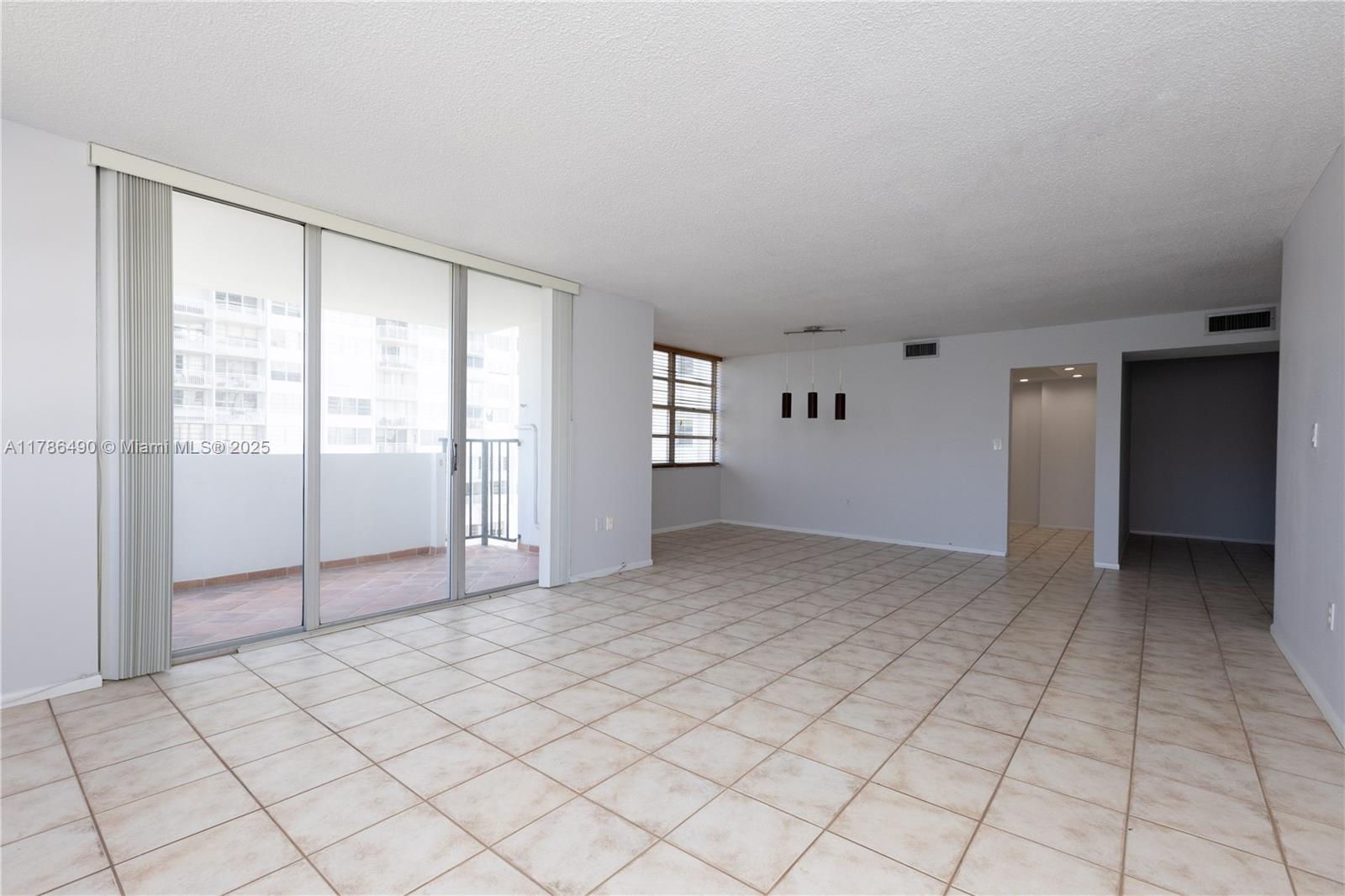 2750 Northeast 183rd Street, Unit 511 Aventura, FL 33160 - Photo 28 of 36 a view of an empty room with window and cabinet area
