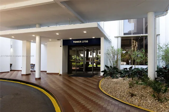 a lobby with furniture and floor to ceiling window