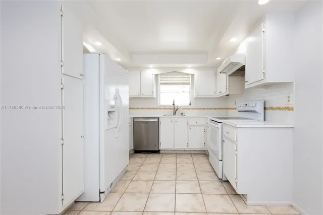 a kitchen with a sink a counter top space and cabinets