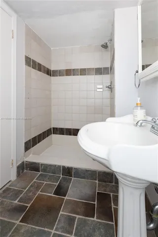 a bathroom with a sink toilet and a mirror