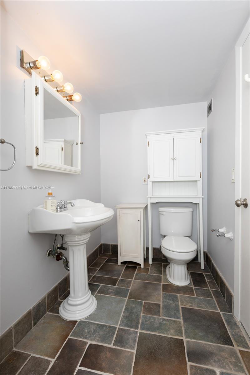 2750 Northeast 183rd Street, Unit 511 Aventura, FL 33160 - Photo 10 of 36 a bathroom with a sink toilet and a mirror