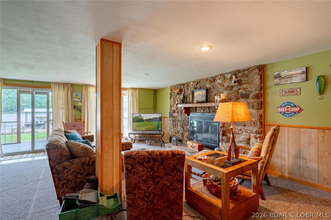 3135 Lick Creek Road Edwards, MO 65326 - Photo 46 of 94 Cozy wood burning fireplace, wall of windows, and