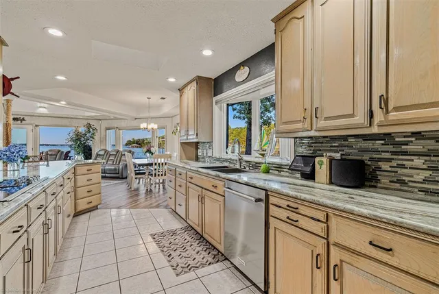 a kitchen with stainless steel appliances granite countertop a sink and cabinets