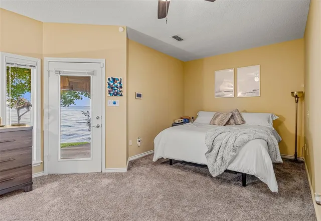 a spacious bedroom with a bed and a table in it