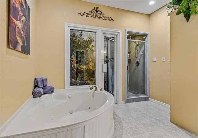 a bathroom with a tub and shower