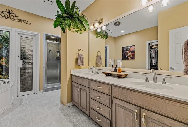 a bathroom with a double vanity sink and a mirror