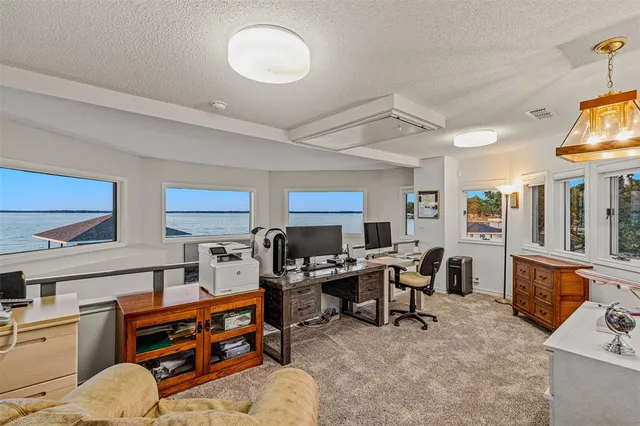 a view of a workspace with furniture and a kitchen