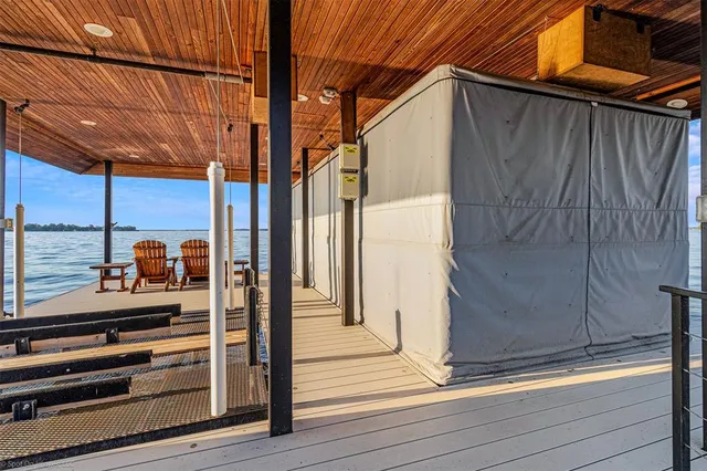 a view of a balcony with door and wooden floor