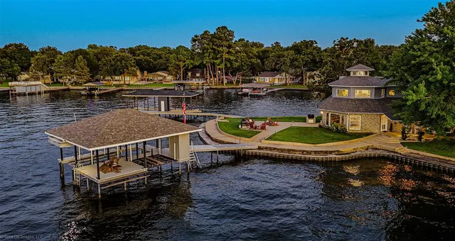 a view of a swimming pool with lawn chairs and a fire pit