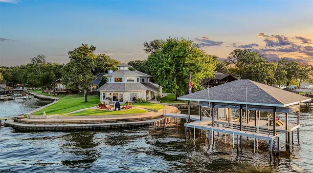 an aerial view of a house with a yard basket ball court and outdoor seating