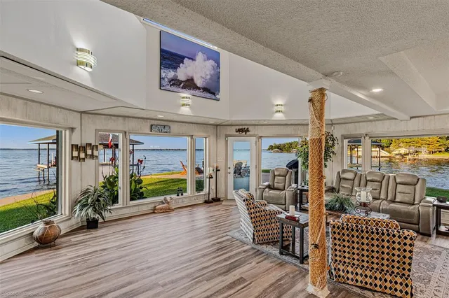 a room with lots of wooden furniture and large windows