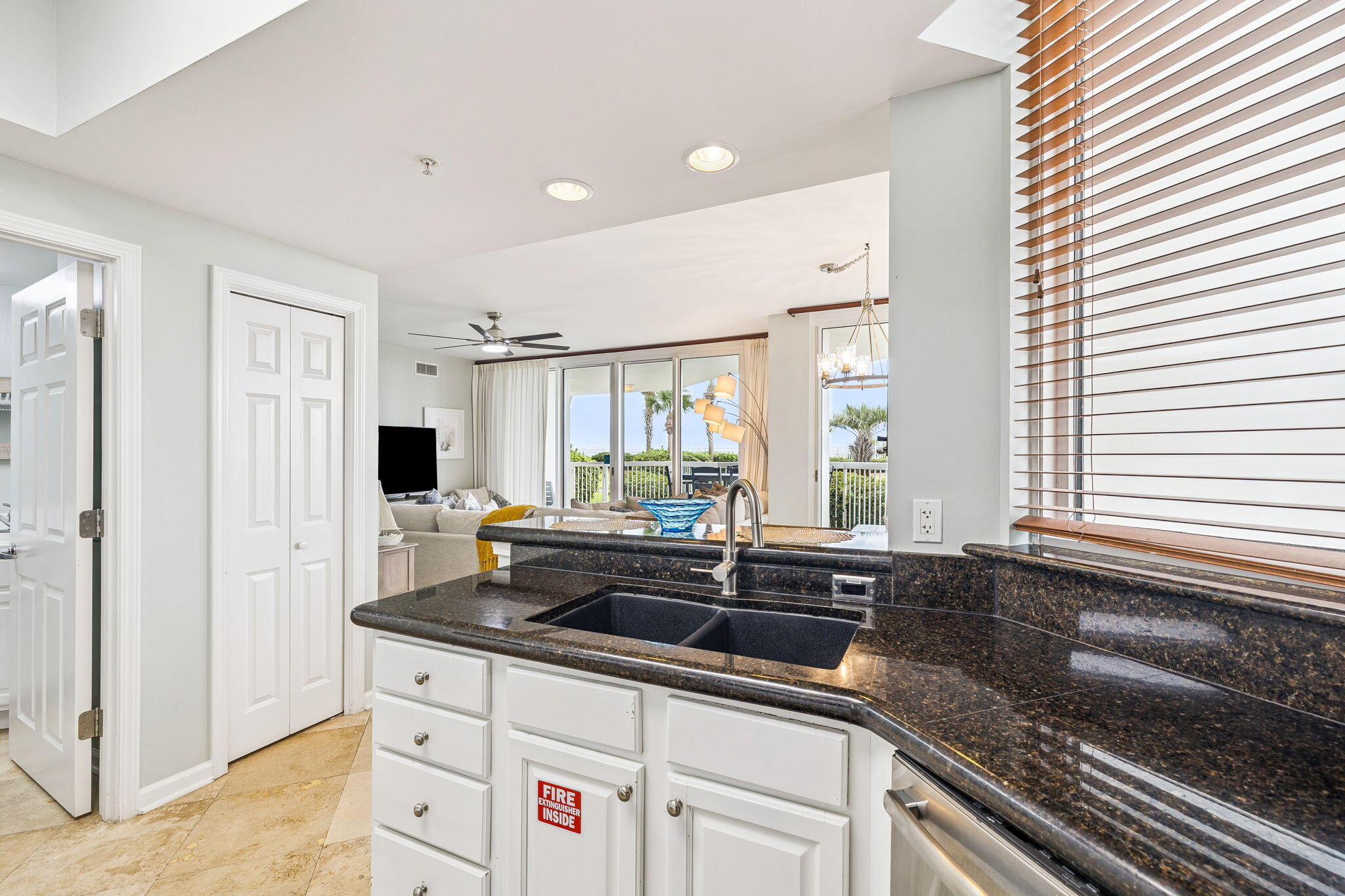 1048 Highway 98, Unit 106W Destin, FL 32541 - Photo 24 of 37 a kitchen with granite countertop a sink and a stove