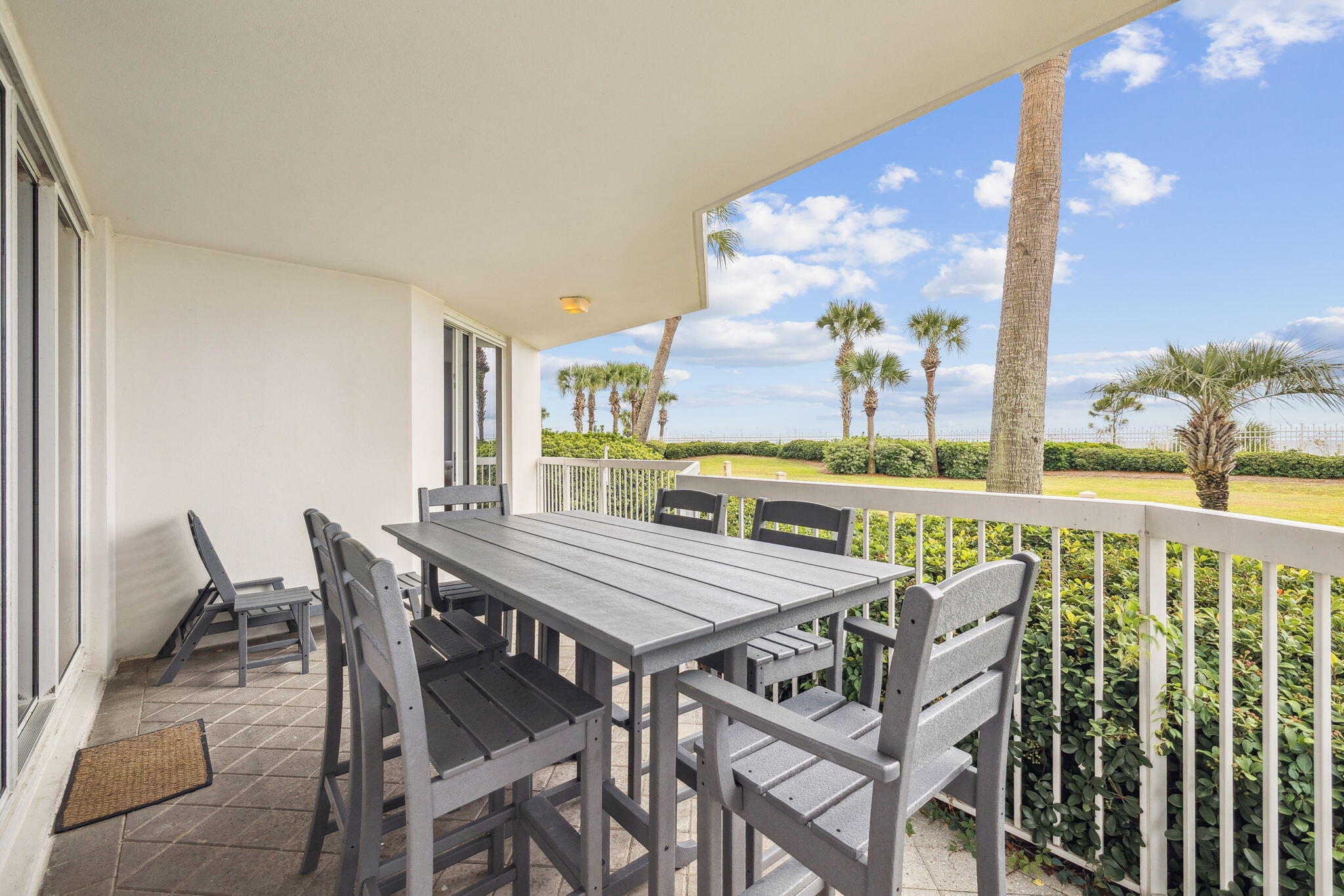 1048 Highway 98, Unit 106W Destin, FL 32541 - Photo 26 of 37 a view of a dining room with furniture and a floor to ceiling window