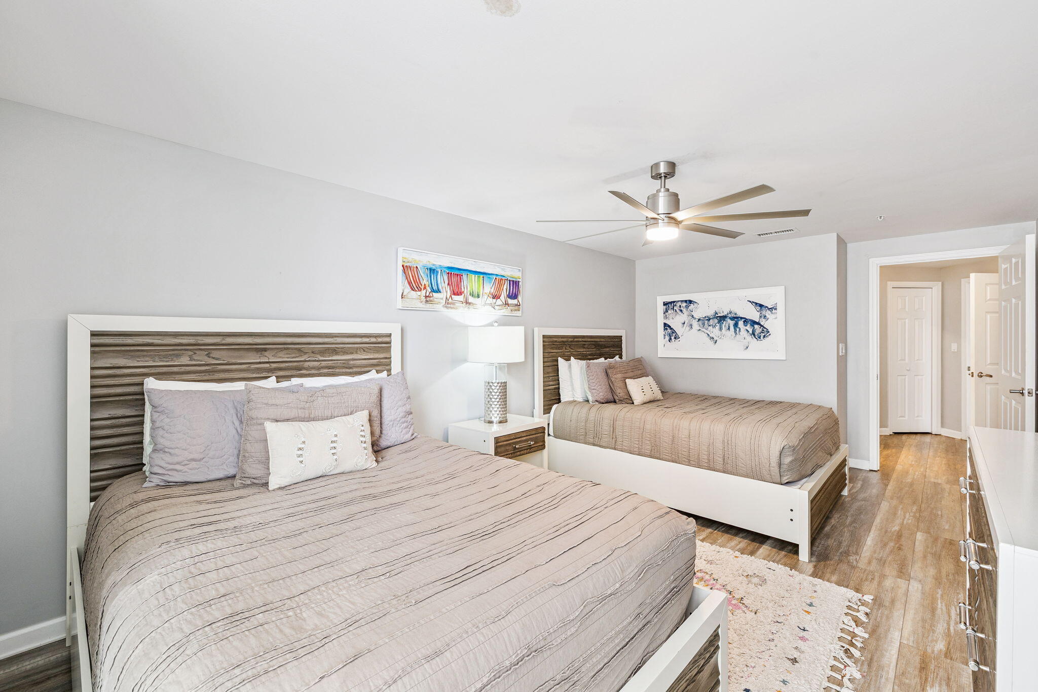 1048 Highway 98, Unit 106W Destin, FL 32541 - Photo 7 of 37 a bedroom with a large bed and a chandelier