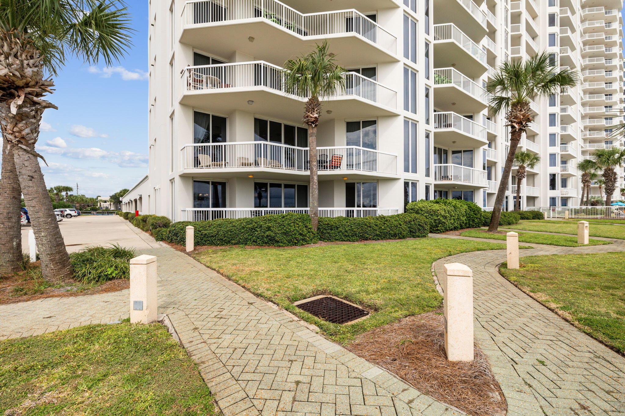 1048 Highway 98, Unit 106W Destin, FL 32541 - Photo 10 of 37 a front view of a residential apartment building with a yard