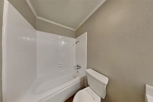 a bathroom with a toilet and a bathtub