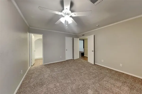 an empty room with fan and a ceiling fan