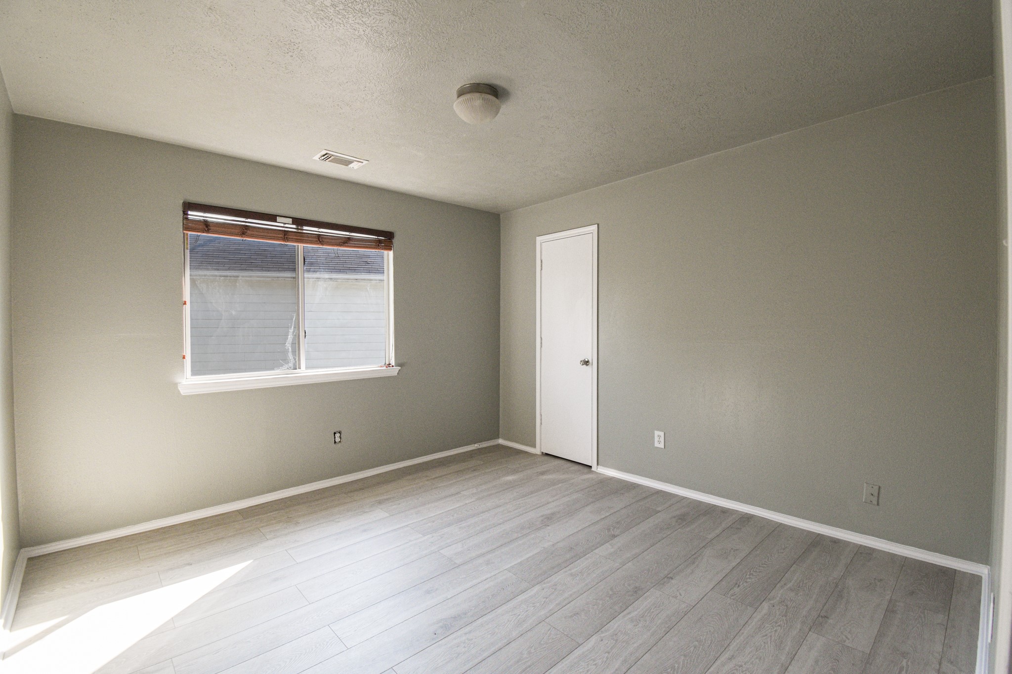 19362 Moss Meadow Lane Katy, TX 77449 - Photo 16 of 35 an empty room with wooden floor and windows