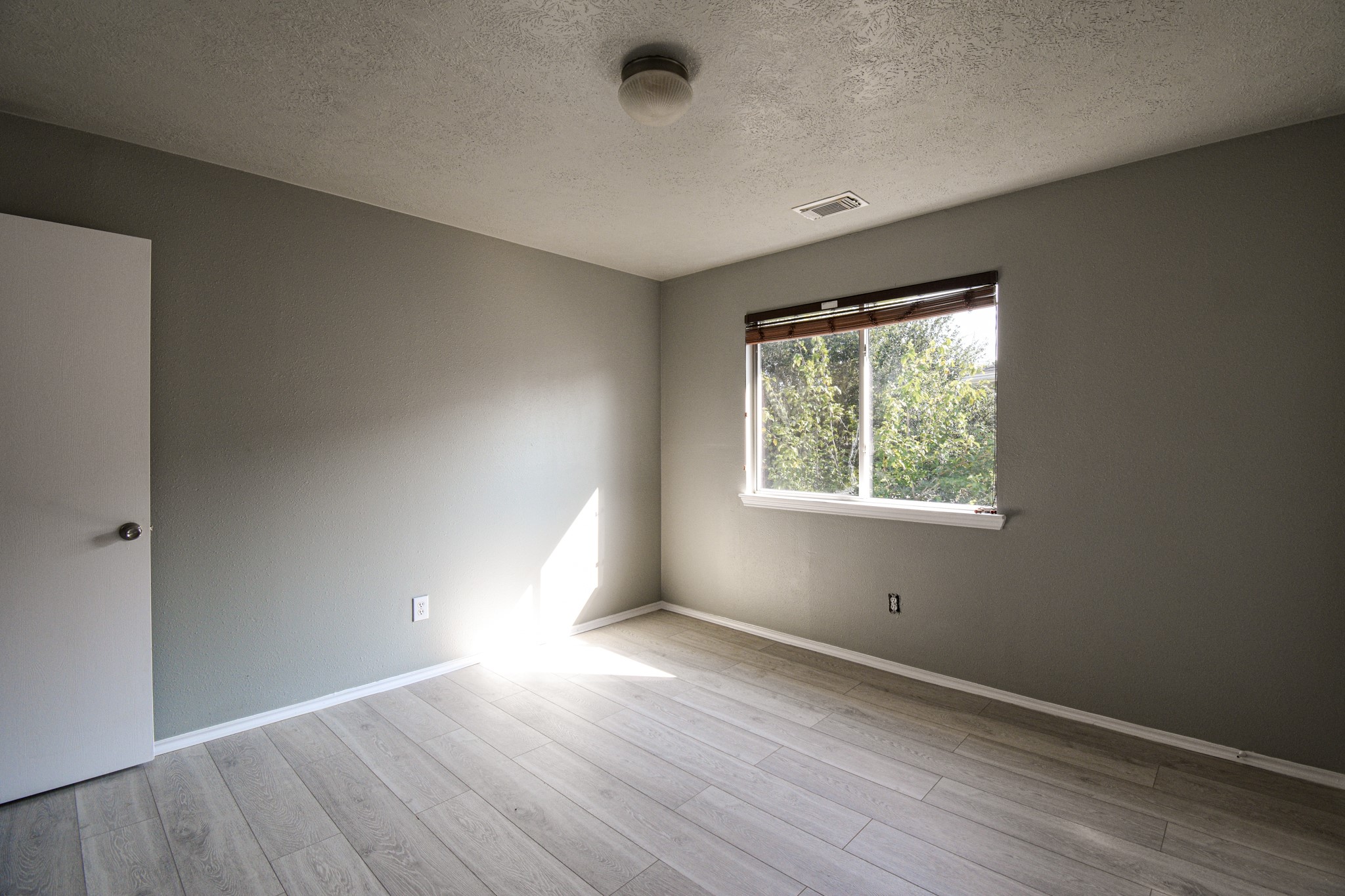 19362 Moss Meadow Lane Katy, TX 77449 - Photo 17 of 35 an empty room with wooden floor and windows
