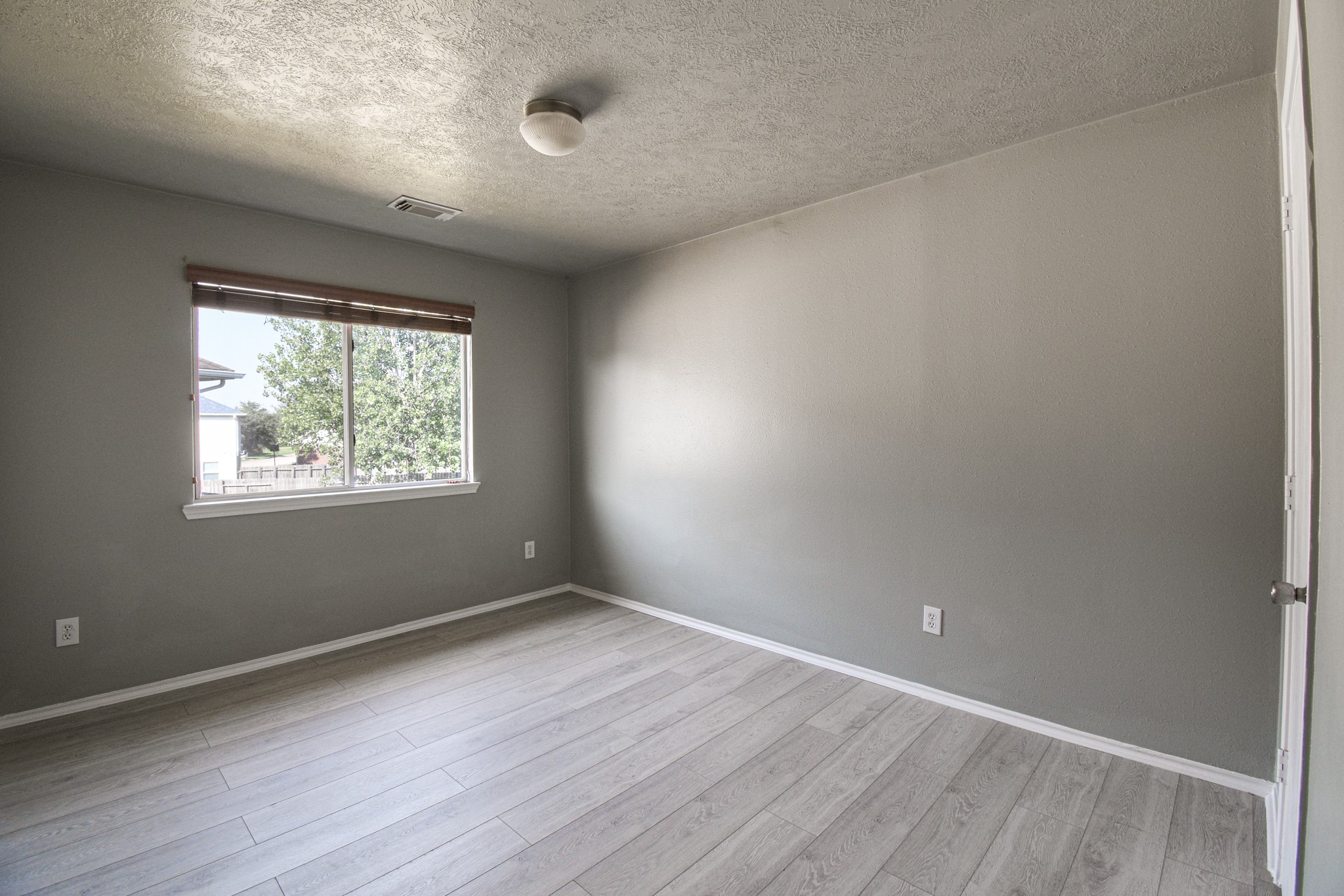 19362 Moss Meadow Lane Katy, TX 77449 - Photo 21 of 35 an empty room with wooden floor and windows