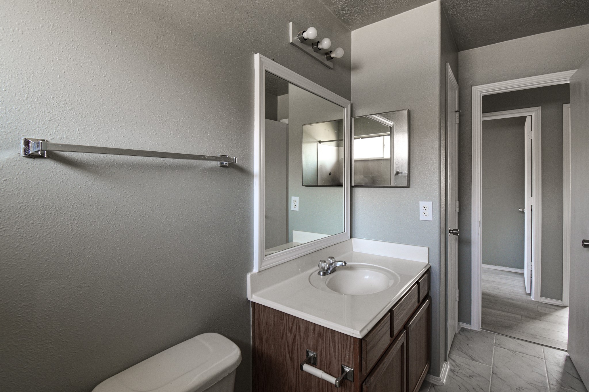19362 Moss Meadow Lane Katy, TX 77449 - Photo 25 of 35 a bathroom with a toilet sink and mirror