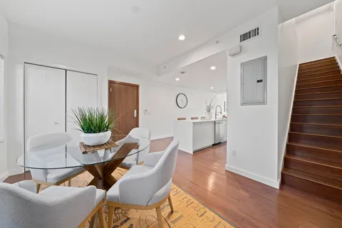 a dining room with furniture and wooden floor