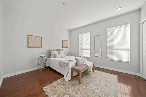 a bed room with a bed and a chair