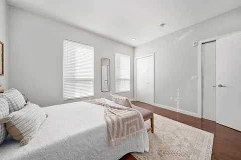 a bedroom with a bed and a window