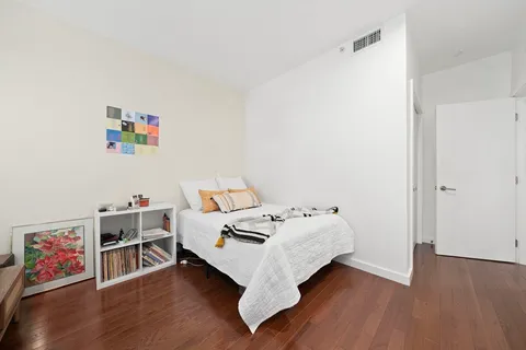 a bed room with a bed and a book shelf