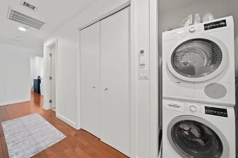 a view of a hallway with washer and dryer