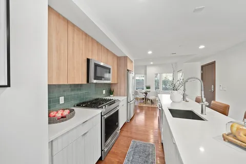 a very nice looking open dining room with kitchen island