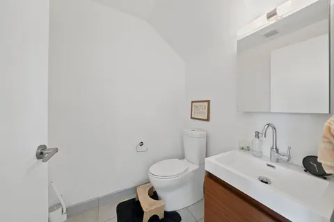 a bathroom with a sink toilet and a mirror