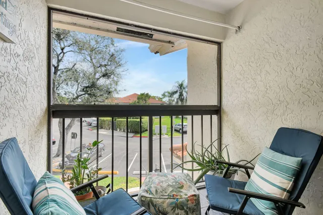 a living room with furniture a fireplace and a chandelier
