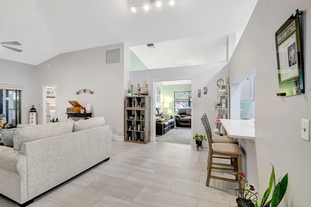 a living room with furniture a rug and a chandelier