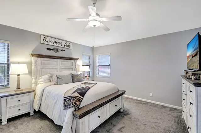 a bathroom with a sink a toilet a mirror and shower