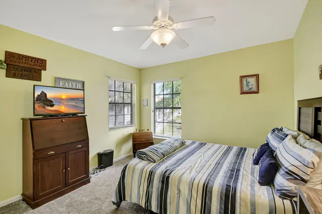 a view of a house with a yard and a tree