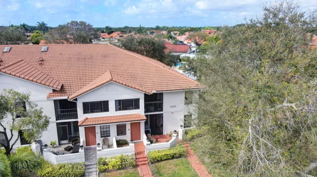 an aerial view of a house with a yard