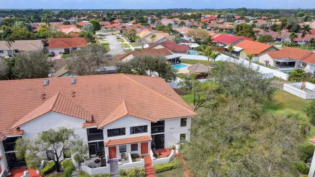 a view of a yard with plants and a small pool