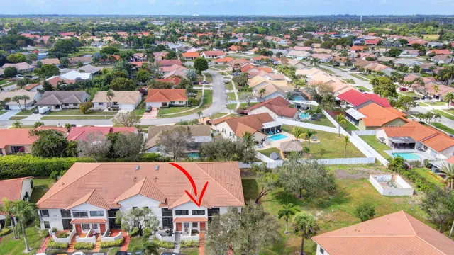 an aerial view of multiple houses with yard