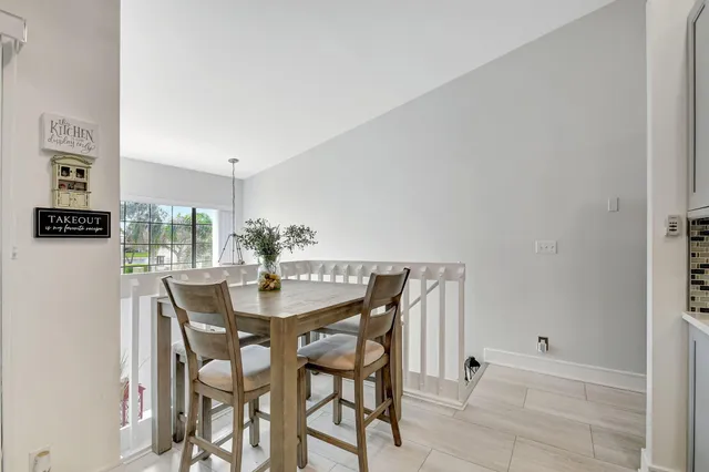 a kitchen with a table chairs appliances and cabinets