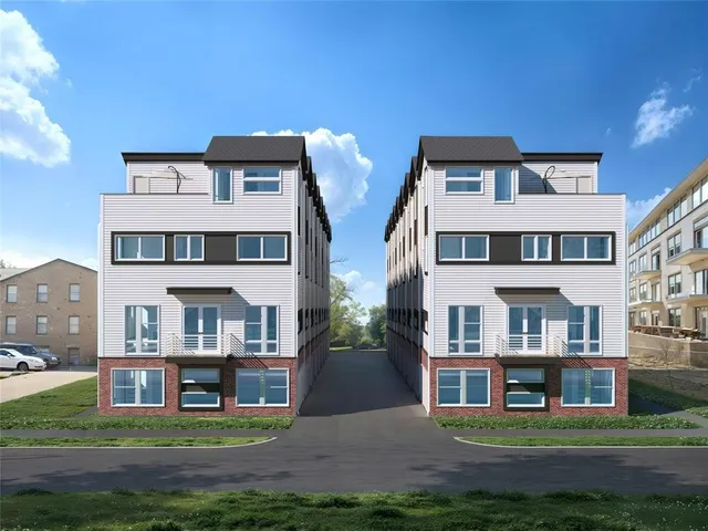 a front view of residential houses with yard and trees